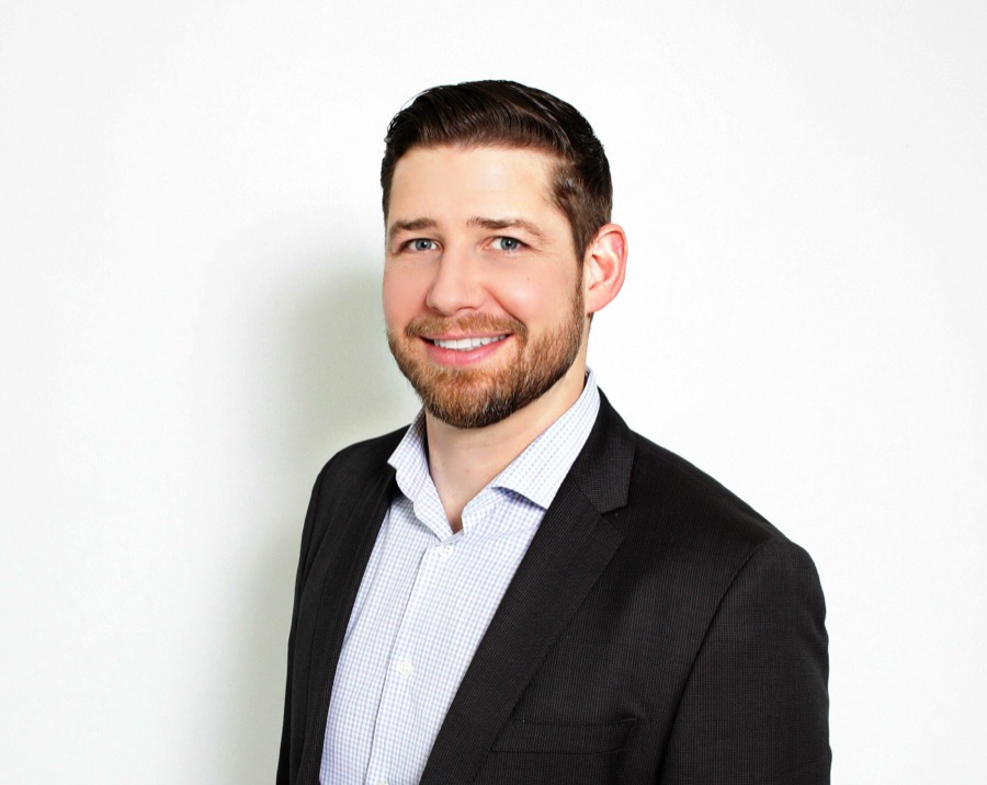 Jordan Thomson, mortgage agent, smiling in a dark blazer